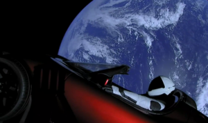 Photo of Tesla Roadster in space with the Earth in the background.