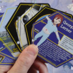 Photo of hexagonal trading cards with character info on them.