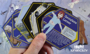 Photo of hexagonal trading cards with character info on them.