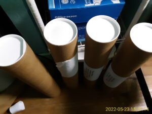 Four large cardboard tubes with plastic end caps.