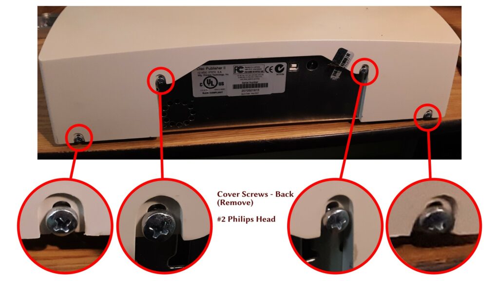 Photo of the back of the machine, showing the location of the four remaining screws holding the shell.