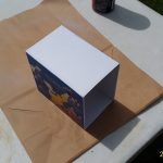 Printed art pasted to sides with spray-on glue.